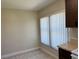 Bright kitchen nook features tiled floor, wood cabinets, and a window with white blinds at 436 Hunter Cir, Kissimmee, FL 34758