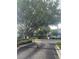 Wrought iron gate to Placid Lake Townhomes with lush landscaping and mature trees at 454 Wilton Cir, Sanford, FL 32773