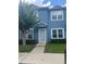 Two-story blue townhome with neatly trimmed hedges and green lawn at 454 Wilton Cir, Sanford, FL 32773