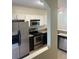 Kitchen featuring white cabinets, stainless steel appliances, and granite countertops at 454 Wilton Cir, Sanford, FL 32773