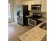 Modern kitchen with stainless steel appliances and granite countertops at 454 Wilton Cir, Sanford, FL 32773