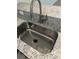 Close-up of stainless steel kitchen sink with granite countertop at 454 Wilton Cir, Sanford, FL 32773
