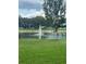 Scenic view of a community pond with a fountain, surrounded by green grass and neighborhood buildings at 454 Wilton Cir, Sanford, FL 32773
