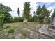 Expansive backyard with lush greenery, mature trees, and a convenient storage shed for outdoor equipment at 535 Romano Ave, Orlando, FL 32807