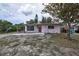 Charming single-story home with a red front door, carport, and partially xeriscaped front yard at 535 Romano Ave, Orlando, FL 32807