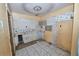Outdated kitchen with damaged walls, missing cabinets and dated tile floors in need of complete renovation at 535 Romano Ave, Orlando, FL 32807