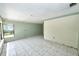 Spacious living room featuring tile flooring, a large window, and fresh paint, perfect for entertaining at 535 Romano Ave, Orlando, FL 32807