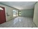 Sunlit living room featuring ceramic tile flooring and a large front window at 535 Romano Ave, Orlando, FL 32807