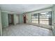 Sunlit living room featuring ceramic tile flooring and a large front window at 535 Romano Ave, Orlando, FL 32807