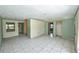 Bright and airy living room with tile floors, multiple entryways, and freshly painted walls at 535 Romano Ave, Orlando, FL 32807