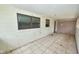 Enclosed patio with tile flooring and windows, offering a transition space for indoor-outdoor living at 535 Romano Ave, Orlando, FL 32807