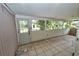 Enclosed patio with tile flooring and windows, offering a transition space for indoor-outdoor living at 535 Romano Ave, Orlando, FL 32807