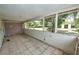 Enclosed patio with tile flooring and windows, offering a transition space for indoor-outdoor living at 535 Romano Ave, Orlando, FL 32807