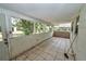 Enclosed patio with tile flooring and windows, offering a transition space for indoor-outdoor living at 535 Romano Ave, Orlando, FL 32807