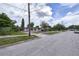 A street view of a neighborhood, featuring a charming single-story home with a covered carport at 535 Romano Ave, Orlando, FL 32807