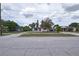 Street view of a single-story home with a red door, set amidst a well-maintained residential neighborhood at 535 Romano Ave, Orlando, FL 32807
