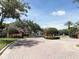 Gated entrance to the community with brick accents and manicured landscaping at 650 Shropshire Loop, Sanford, FL 32771
