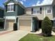 Charming townhome featuring a one-car garage and inviting facade with lush landscaping at 650 Shropshire Loop, Sanford, FL 32771