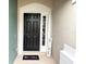 Inviting front entrance with a stylish black door and decorative welcome mat at 650 Shropshire Loop, Sanford, FL 32771