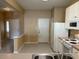 Kitchen with stainless sink, white cabinets, and view of front entry at 650 Shropshire Loop, Sanford, FL 32771