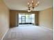 Spacious living room with sliding glass doors leading to screened lanai and water view at 650 Shropshire Loop, Sanford, FL 32771