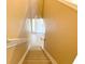 Carpeted staircase features neutral walls, white trim, and leads to the front door and foyer of this lovely home at 650 Shropshire Loop, Sanford, FL 32771