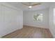 Bright bedroom with wood-look floors, closet and modern ceiling fan at 814 Roseapple Ave, Lady Lake, FL 32159