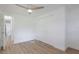 Bedroom features wood-look floors, ceiling fan, and closet at 814 Roseapple Ave, Lady Lake, FL 32159