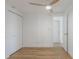 Bedroom features wood-look floors, closet, and view to front door at 814 Roseapple Ave, Lady Lake, FL 32159
