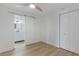 Bedroom features wood-look floors, closet, and view to bathroom at 814 Roseapple Ave, Lady Lake, FL 32159