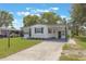 Charming single-story home with a carport and well-maintained front lawn in a quiet community at 814 Roseapple Ave, Lady Lake, FL 32159