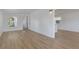 View of the living room and kitchen area, with laminate floors and white walls at 814 Roseapple Ave, Lady Lake, FL 32159