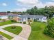 Aerial view of a charming home featuring a circular driveway, mature landscaping, and a well-maintained lawn at 830 Hawkes Ave, Orlando, FL 32809