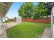 Spacious backyard with partial patio and white lattice pergola and tall mature trees at 830 Hawkes Ave, Orlando, FL 32809