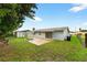 Backyard with a small patio, storage shed, and privacy fence at 830 Hawkes Ave, Orlando, FL 32809