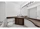 Bathroom with a tub, toilet, and wood vanity, designed to maximize the room's layout at 830 Hawkes Ave, Orlando, FL 32809