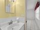 Bathroom featuring modern faucet, mirror, and white tiled walls, creating a bright and clean space at 830 Hawkes Ave, Orlando, FL 32809