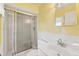 Bathroom featuring a glass-enclosed shower, clean white fixtures, and a well-lit vanity area at 830 Hawkes Ave, Orlando, FL 32809