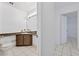 This bathroom includes a toilet, wood vanity, and large mirror, offering a functional and stylish space at 830 Hawkes Ave, Orlando, FL 32809