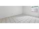 Bedroom featuring tile flooring and a window with lattice accents at 830 Hawkes Ave, Orlando, FL 32809