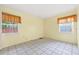A bright bedroom with white tile floors and windows, offering a clean and minimalist design at 830 Hawkes Ave, Orlando, FL 32809