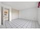 A spacious bedroom with ample closet space and tile flooring that creates a seamless look at 830 Hawkes Ave, Orlando, FL 32809