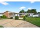 Inviting single-story home featuring a manicured lawn and tidy landscaping at 830 Hawkes Ave, Orlando, FL 32809
