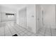 Hallway with tiled floors, closet, and window looking to the front yard at 830 Hawkes Ave, Orlando, FL 32809