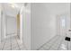 Hallway featuring tile flooring, a closet, and a view of the front door at 830 Hawkes Ave, Orlando, FL 32809