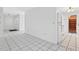 Kitchen featuring tile flooring, white cabinets, and a view of the front door at 830 Hawkes Ave, Orlando, FL 32809