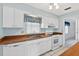 Bright kitchen features white cabinets, matching appliances, and wood countertops with a stainless sink at 830 Hawkes Ave, Orlando, FL 32809