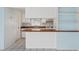 Bright kitchen features white cabinets, matching appliances, and wood countertops with a breakfast bar at 830 Hawkes Ave, Orlando, FL 32809