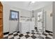 Laundry area with washer, dryer, and checkered flooring for a practical space for chores at 830 Hawkes Ave, Orlando, FL 32809