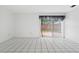 Bright living room featuring tile flooring and sliding glass doors to the backyard at 830 Hawkes Ave, Orlando, FL 32809